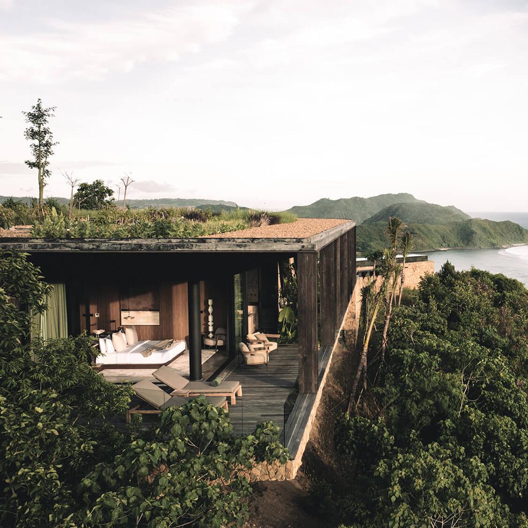 A villa with a planted roof on the hillside above Tampah Bay